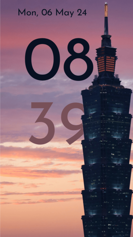 Lock screen with a tall Taipei tower in front of a purple and orange sunset sky; the large hour and minute digits sit in the sky, with the tower overlapping the minutes.
